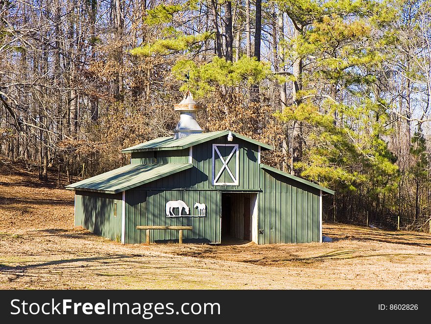 A green barn in a horse pasture. A green barn in a horse pasture