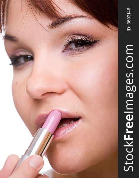 Attractive woman doing makeup. over white background