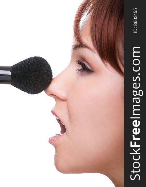 Attractive woman doing makeup. over white background