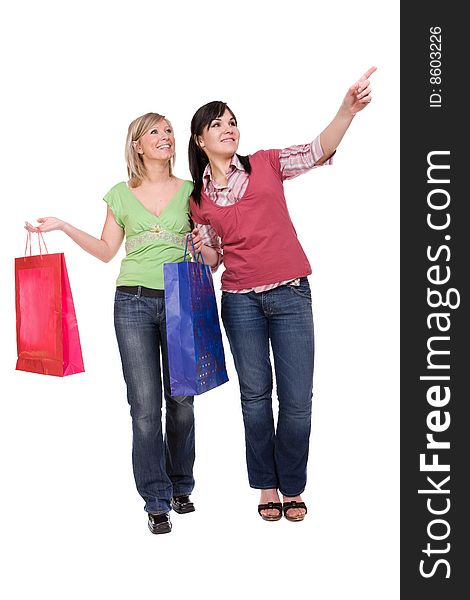 Two attractive women with shopping bags. over white background. Two attractive women with shopping bags. over white background