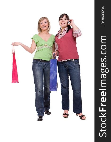 Two attractive women with shopping bags. over white background. Two attractive women with shopping bags. over white background