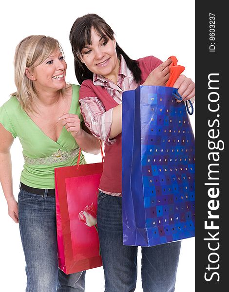 Two attractive women with shopping bags. over white background. Two attractive women with shopping bags. over white background