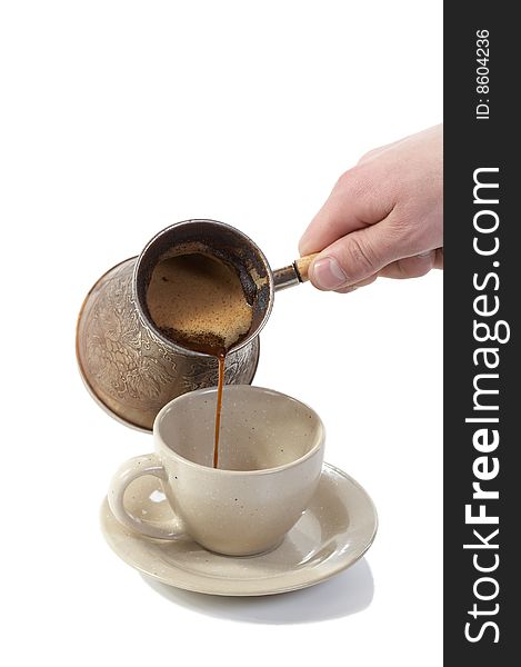 Coffee poured from coffee maker in cup on a white background. Coffee poured from coffee maker in cup on a white background