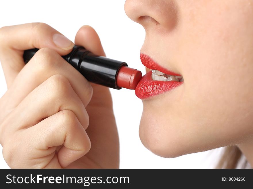 Young woman doing make-up over white