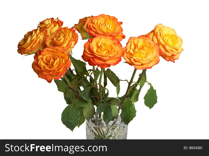 A bouquet of yellow roses in a crystal vase