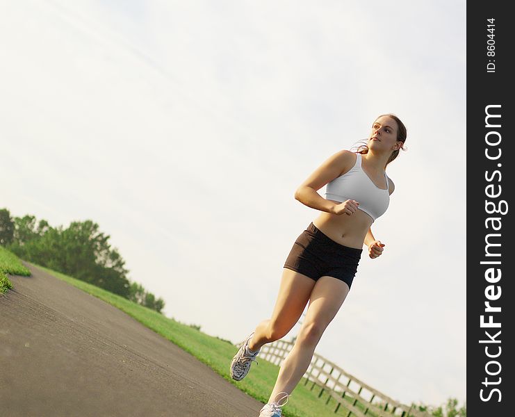 Beautiful young woman runner having a workout session. Beautiful young woman runner having a workout session.