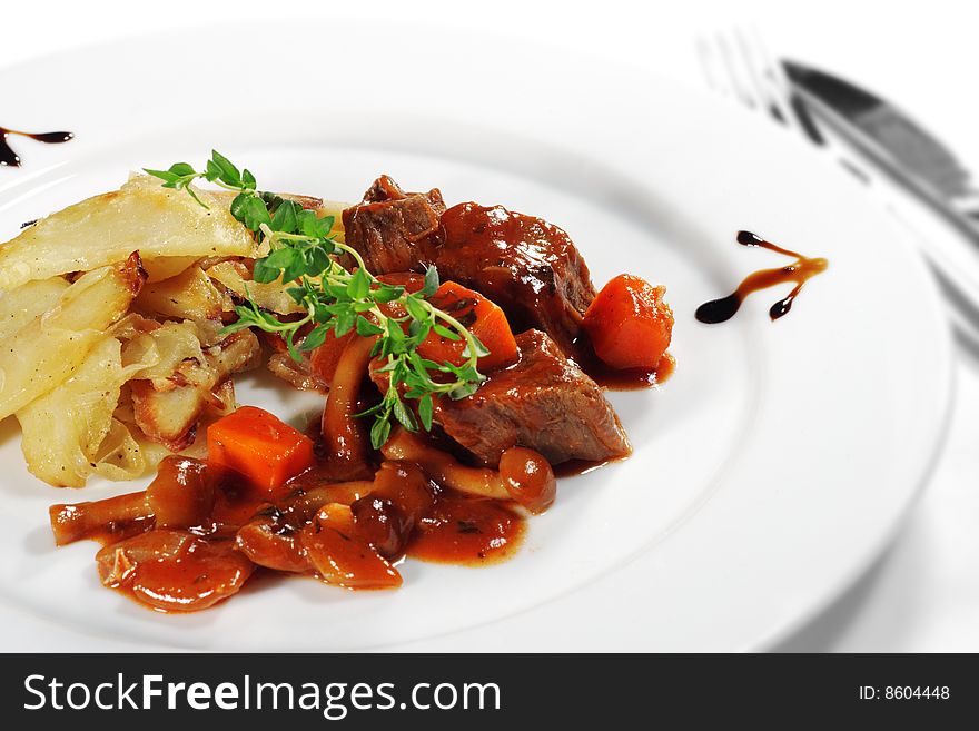 Stewed Beef with Potato Served with Green. Isolated on White Background
