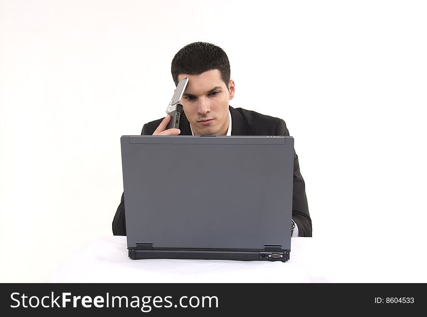 Businessman with lap top computer and phone.
