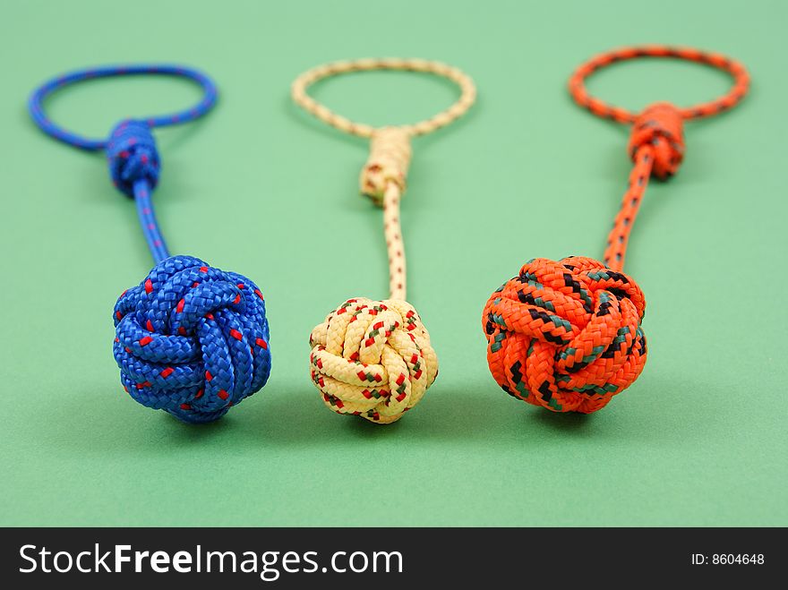 Colorful strings are lying on green background