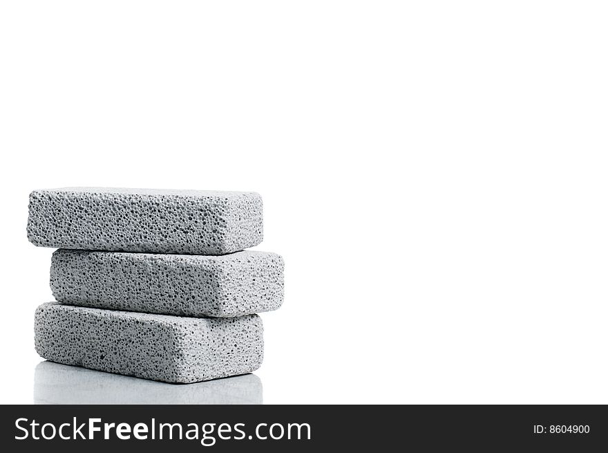 A stack of pumice stones against a white background. A stack of pumice stones against a white background.
