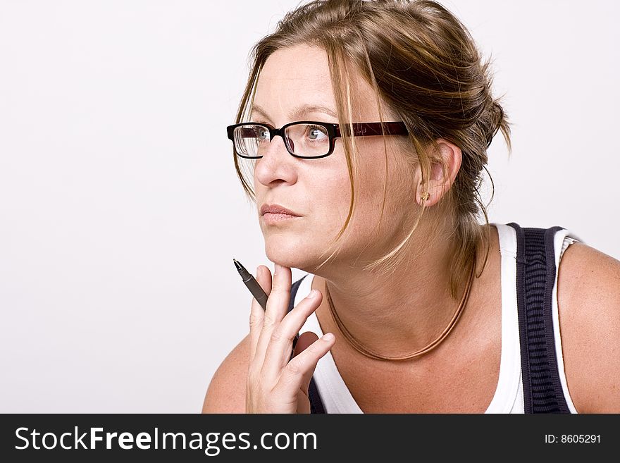 Woman thinking or listening. She is focused with a pencil in her hand