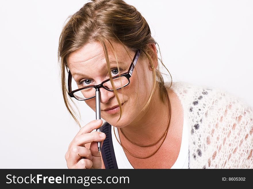 Beautiful woman looking into camera with a friendly smile. She has a pencil in her hand. Beautiful woman looking into camera with a friendly smile. She has a pencil in her hand.