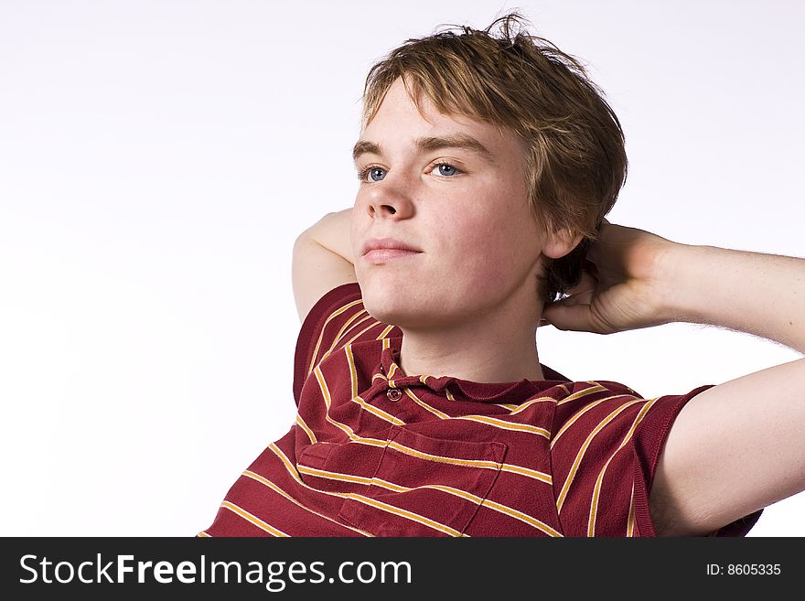 Teenage boy looking sitting with arms behind his head thinking. Teenage boy looking sitting with arms behind his head thinking