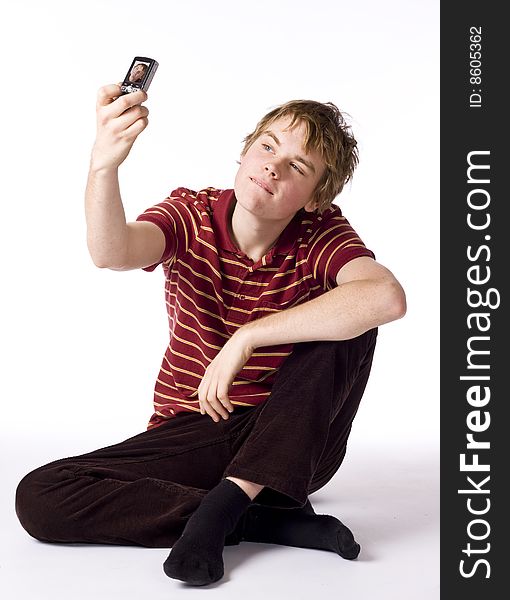 Teenage boy taking his picture with cell phone. Teenage boy taking his picture with cell phone