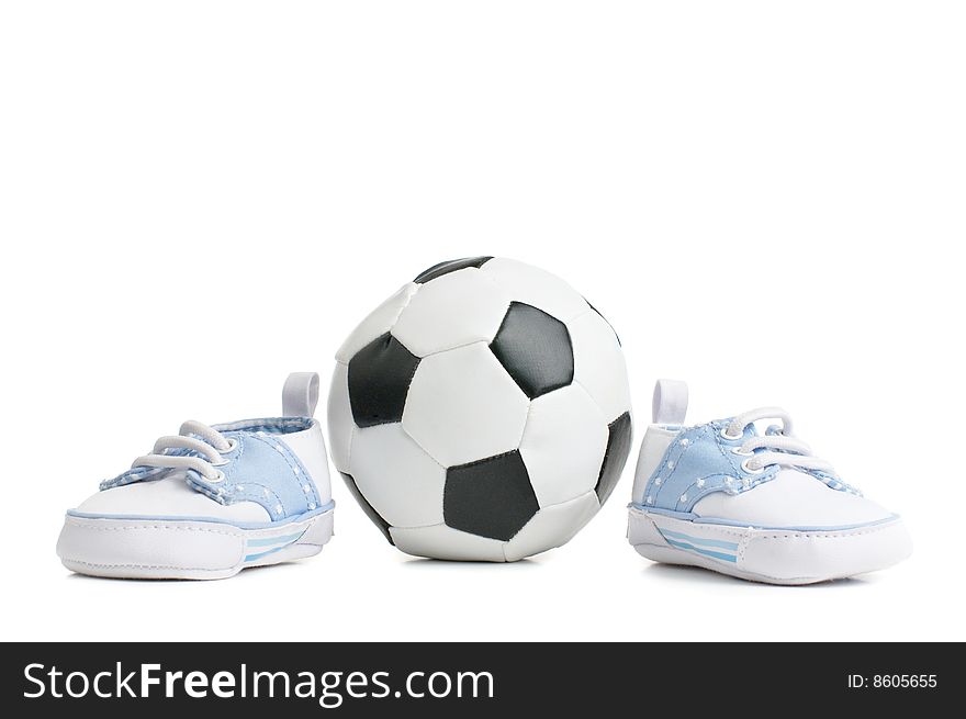 A football / soccer ball with baby shoes, on white.