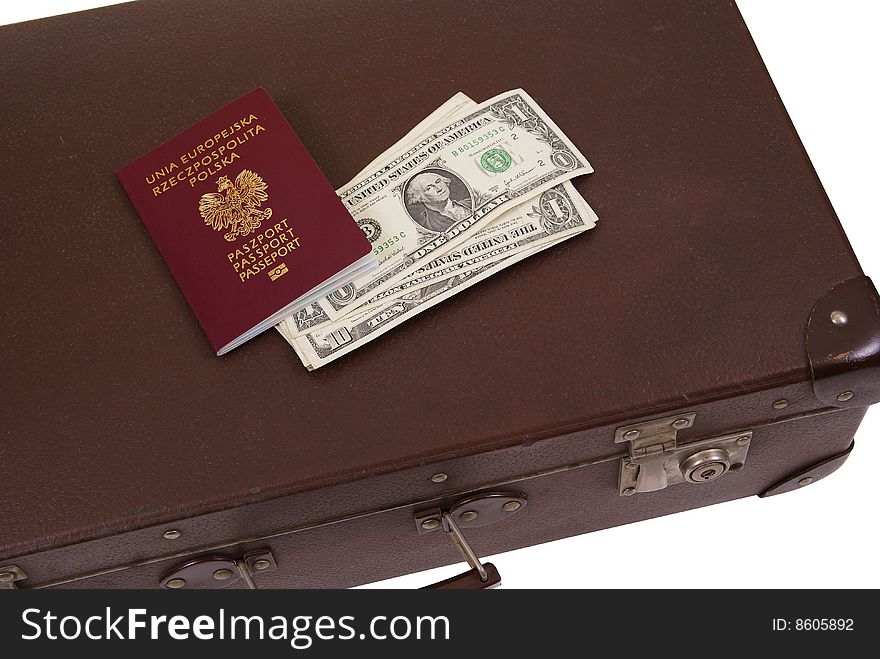 Old suitcase with money and passport isolated on white background