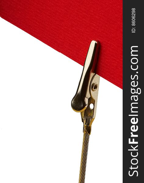 Metal clip holding a red card