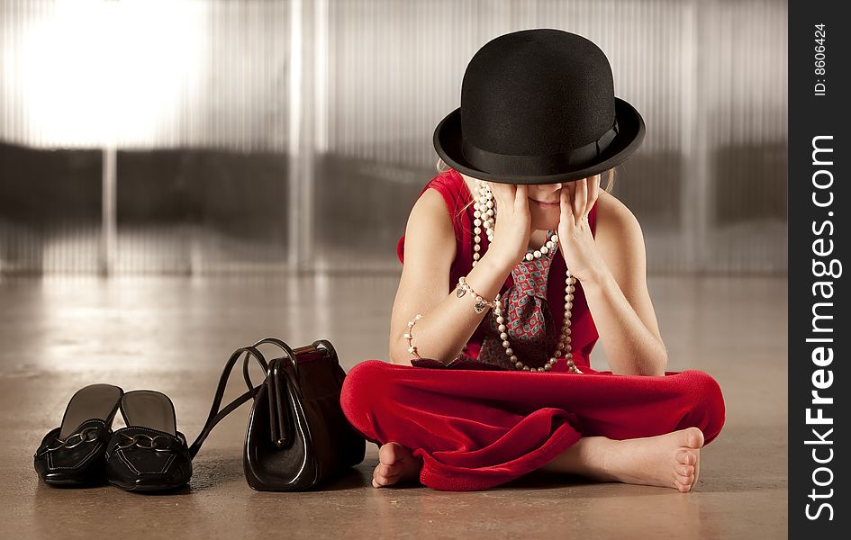 Young girl with her face hidden in her hat. Young girl with her face hidden in her hat