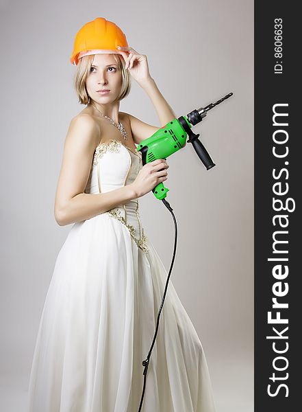 Girl In Evening Dress With A Drill