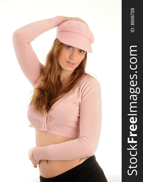 Young woman posing, wearing sexy clothes and a cap.