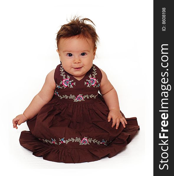 Adorable little baby wearing brown dress isolated against white background