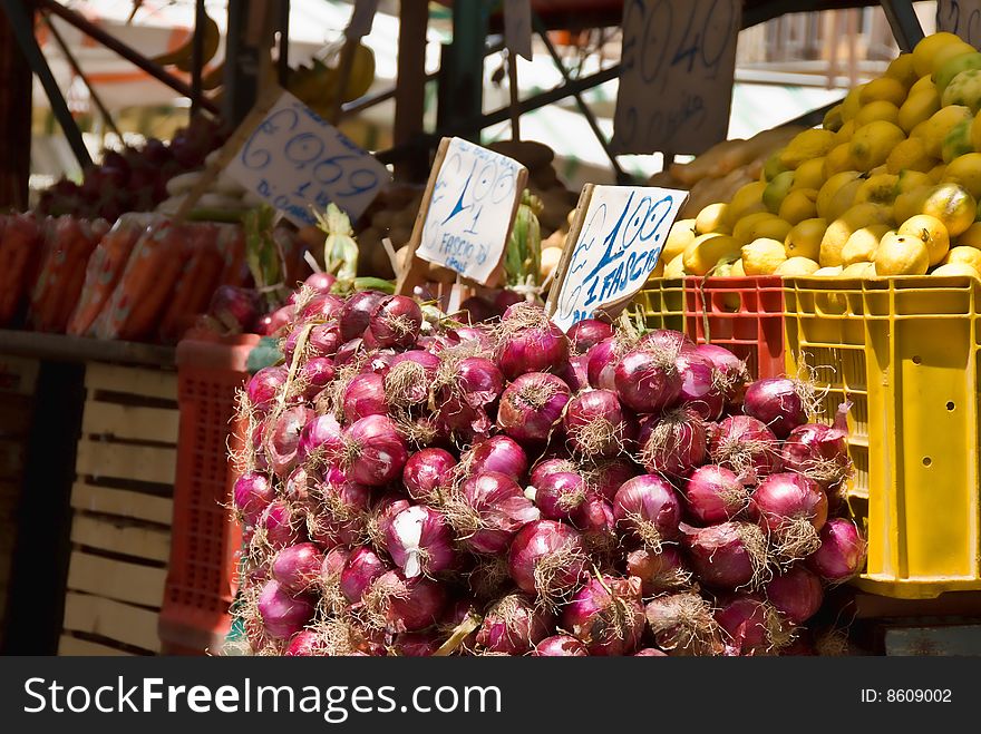 Red onions along with other fruits and vegetables for sale at a Farmer's Market in Palermo, Sicily. Red onions along with other fruits and vegetables for sale at a Farmer's Market in Palermo, Sicily.