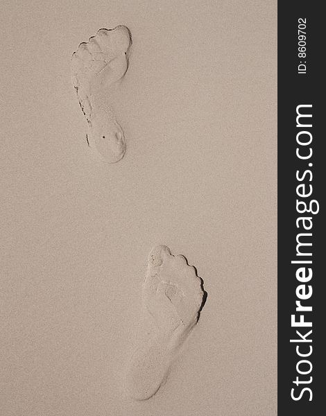 Foot prints on sand beach.