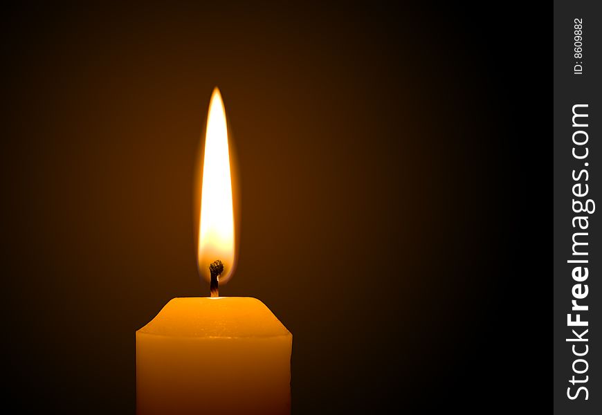 Macro of burning candle on black background