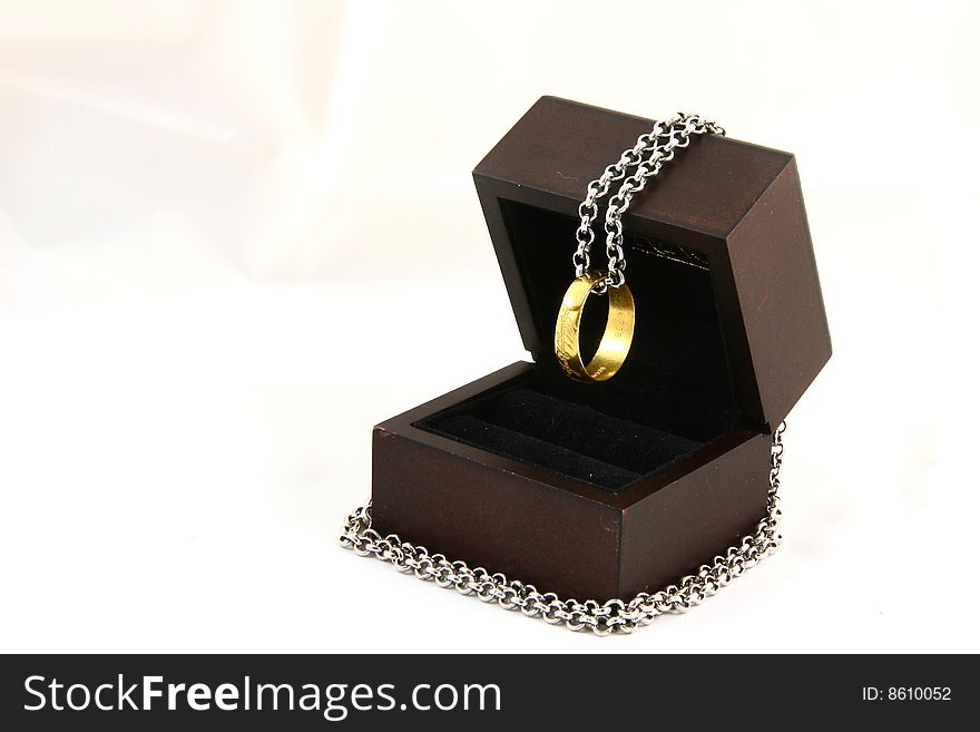 Gold ring with chains in a wood box