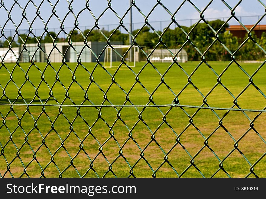 Green football ground and fence