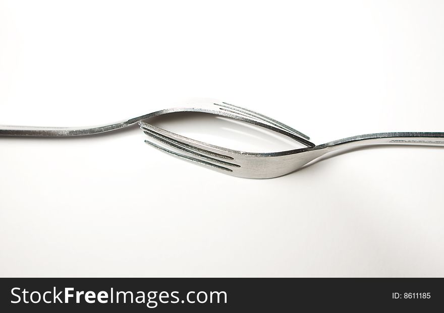 A pair of fork place in line with each other. A pair of fork place in line with each other