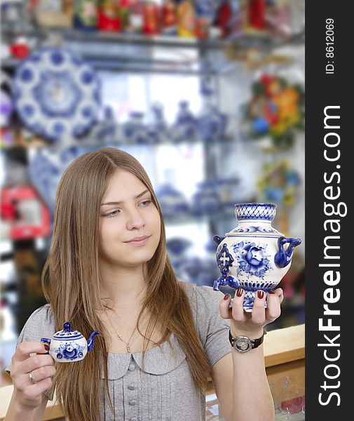 The young woman buys china. The young woman buys china