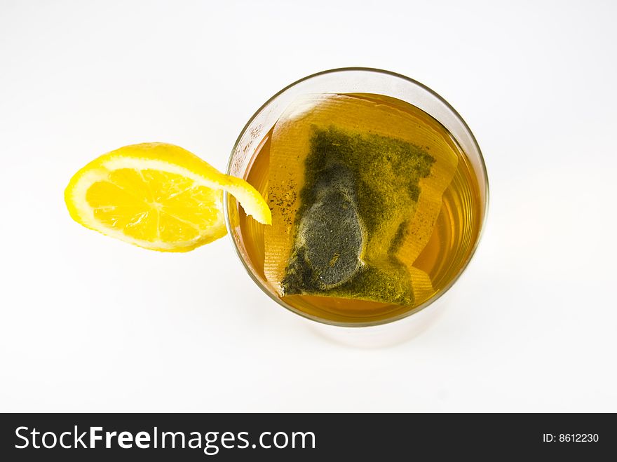 Glass of herbal tea with lemon on the side