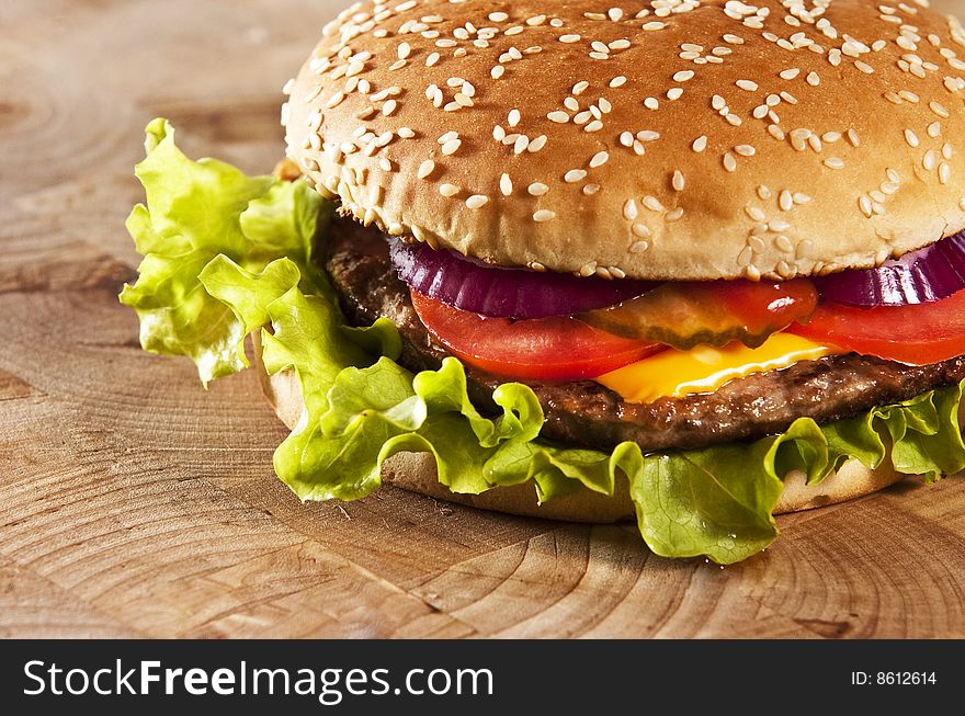 Cheeseburger with onions tomato and ketchup. Cheeseburger with onions tomato and ketchup