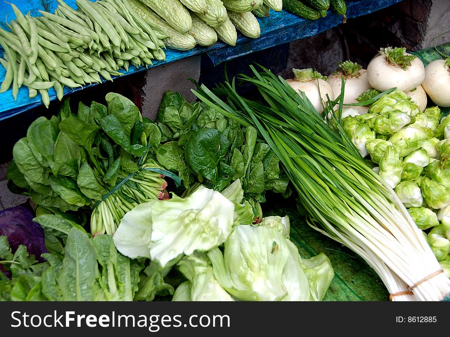 Beans, chard, bok choy, turnips, and green onions are displayed at the Tian Fu outdoor market in Pengzhou, Sichuan province, China - Lee Snider Photo. Beans, chard, bok choy, turnips, and green onions are displayed at the Tian Fu outdoor market in Pengzhou, Sichuan province, China - Lee Snider Photo.