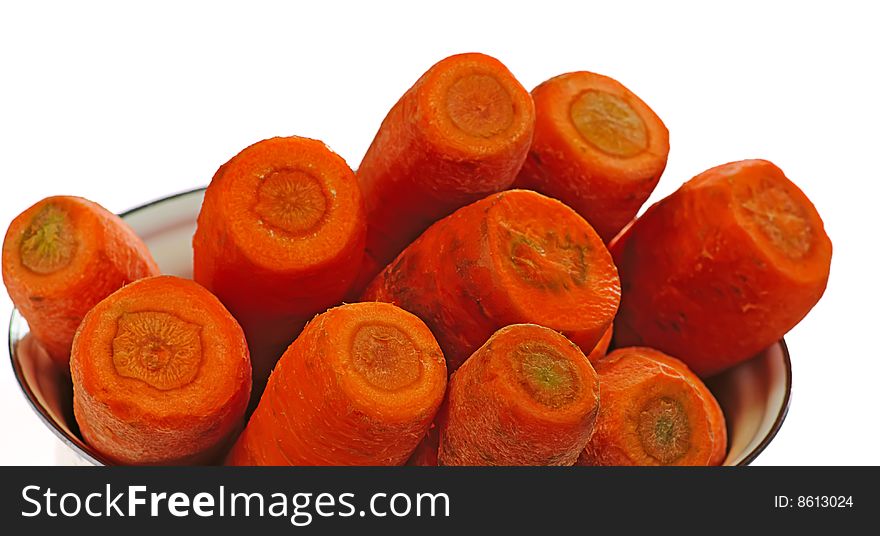 Raw carrots in pot on white