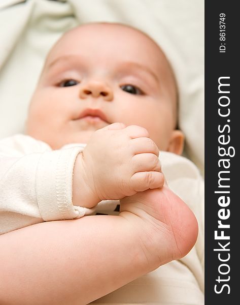 A baby playing with his foot