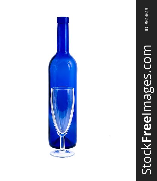 An empty blue bottle and wineglass isolated on white