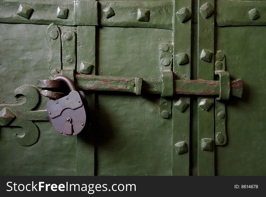 Old green iron door with lock. Old green iron door with lock
