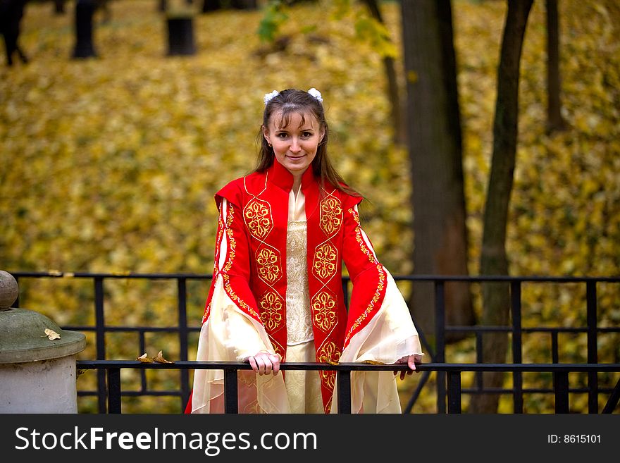 Lady in medieval red dress in the autumn forest. Lady in medieval red dress in the autumn forest