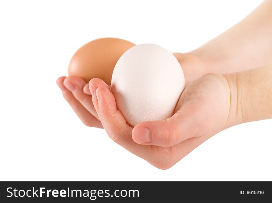 White and brown chicken egg in woman's hand. White and brown chicken egg in woman's hand