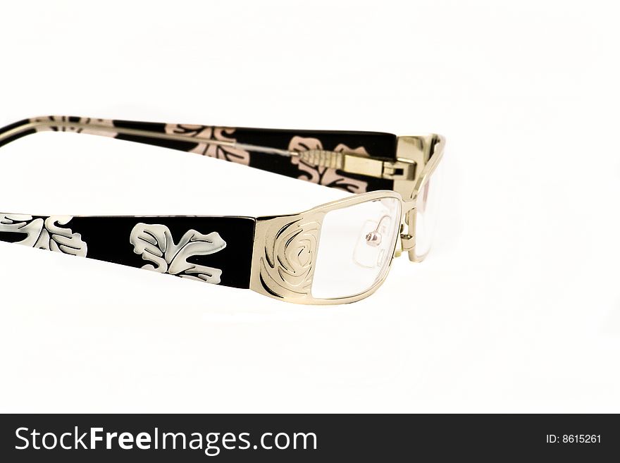 Close up view at woman's glasses on a white background. Close up view at woman's glasses on a white background