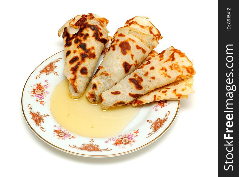 Pancakes with honey, isolated on white