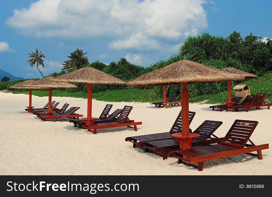 Beautiful Tropical Beach with rows of  reclining chairs