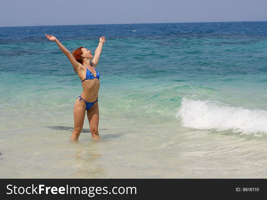 The girl in the sea with the hands lifted upwards