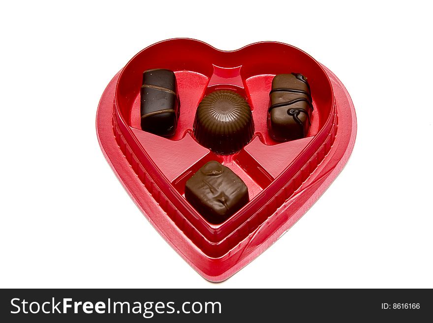 Chocolate candy in a red heart shaped box for valentine's day. Chocolate candy in a red heart shaped box for valentine's day