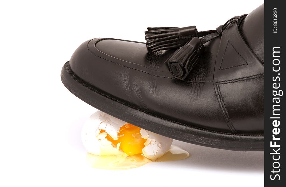 Dress shoe walking on egg shells representing tension or making a big mess.
