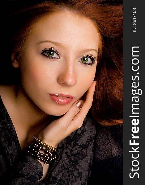 Studio portrait of a beautiful young girl with red hair