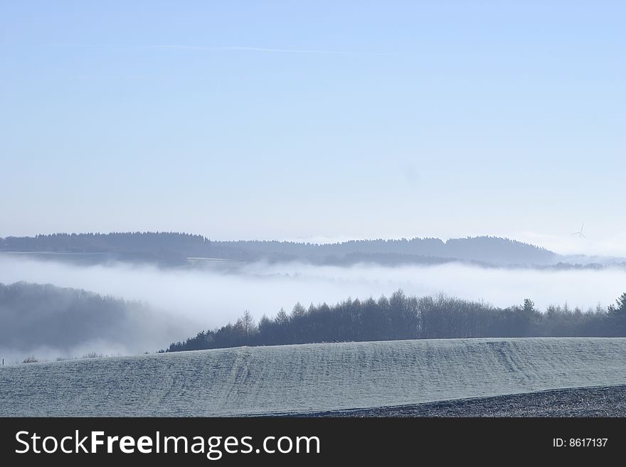 Fog over frozen ridges and slopes. Fog over frozen ridges and slopes
