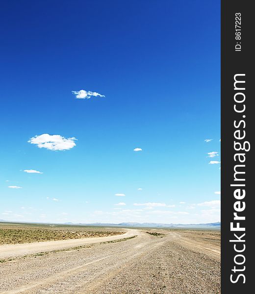 Desert road in Mongolia with dramatic sky. Desert road in Mongolia with dramatic sky